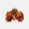Pair of colorful butterfly-shaped hair clips with leopard print accents on a light pink background