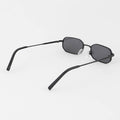 Black sunglasses with thin frame on a white background