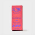 A tall rectangular pink product box with blue text and graphics, standing upright on a light gray studio background. The box prominently reads BLOMB and appears to be the packaging for a scent product.