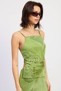 Woman wearing a green dress with a plain background