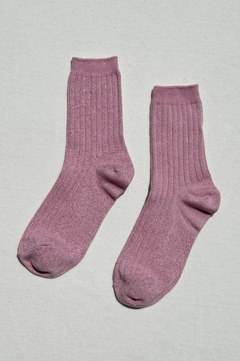 Pair of pink socks on a light gray background