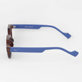 Sunglasses with blue frames and wooden temple tips on a white background