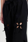 Black pants with cut-out design on a white background