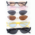Set of cat-eye sunglasses with different lens colors on a white background