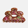 Multicolored hair claw clip on a white background