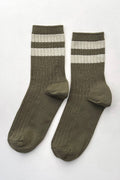 A pair of ribbed crew socks in olive green with two horizontal cream stripes near the cuff, displayed on a light gray background.
