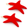 Red starfish-shaped earrings on a white background