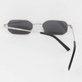 Sunglasses with black lenses and silver frames on a white background