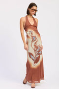Woman wearing a brown dress with a floral pattern on a white background