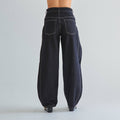 Black wide-leg jeans on a plain background