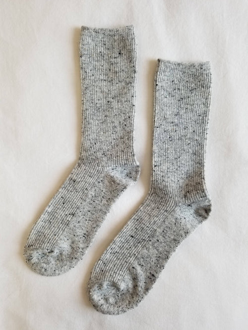 Pair of gray socks on a light beige background