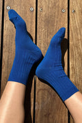 Blue socks worn on a wooden floor