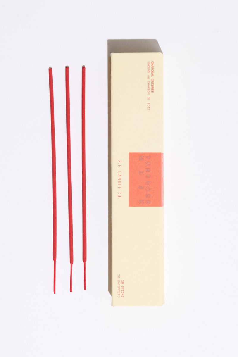 Red incense sticks with a beige box on a white background