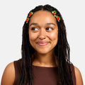 Young woman with braided hair wearing decorative headbands against a white background