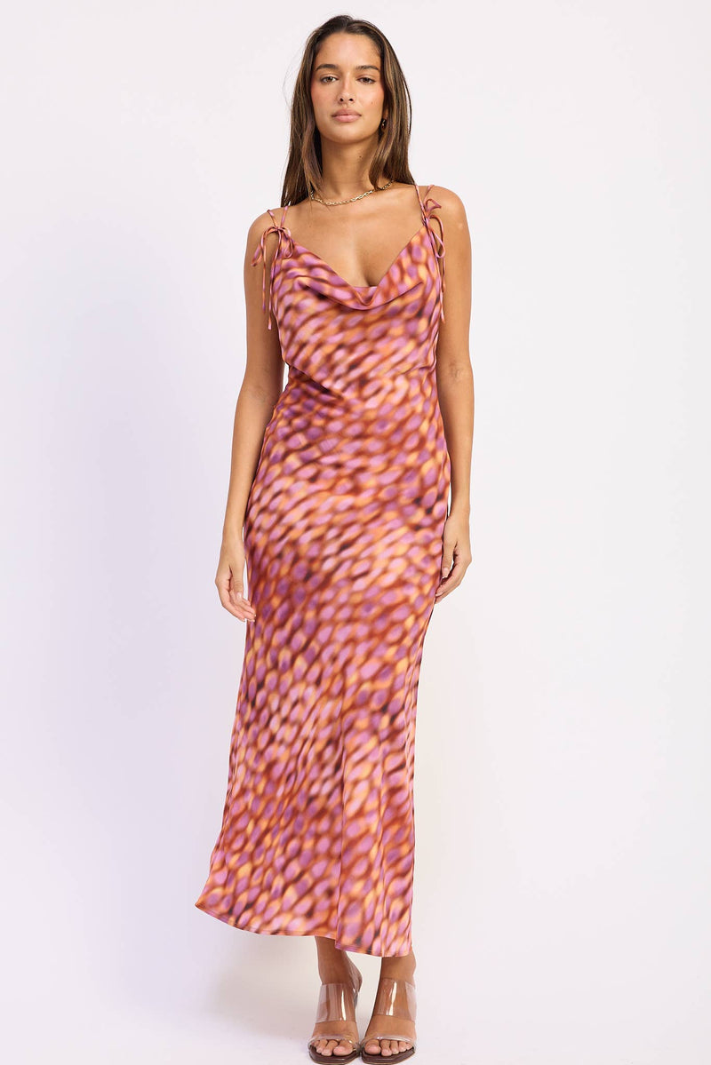 Woman wearing a patterned dress on a white background
