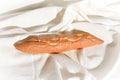 Long rectangular bread roll on a white fabric background