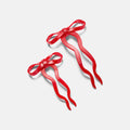 Two red ribbons on a light gray background