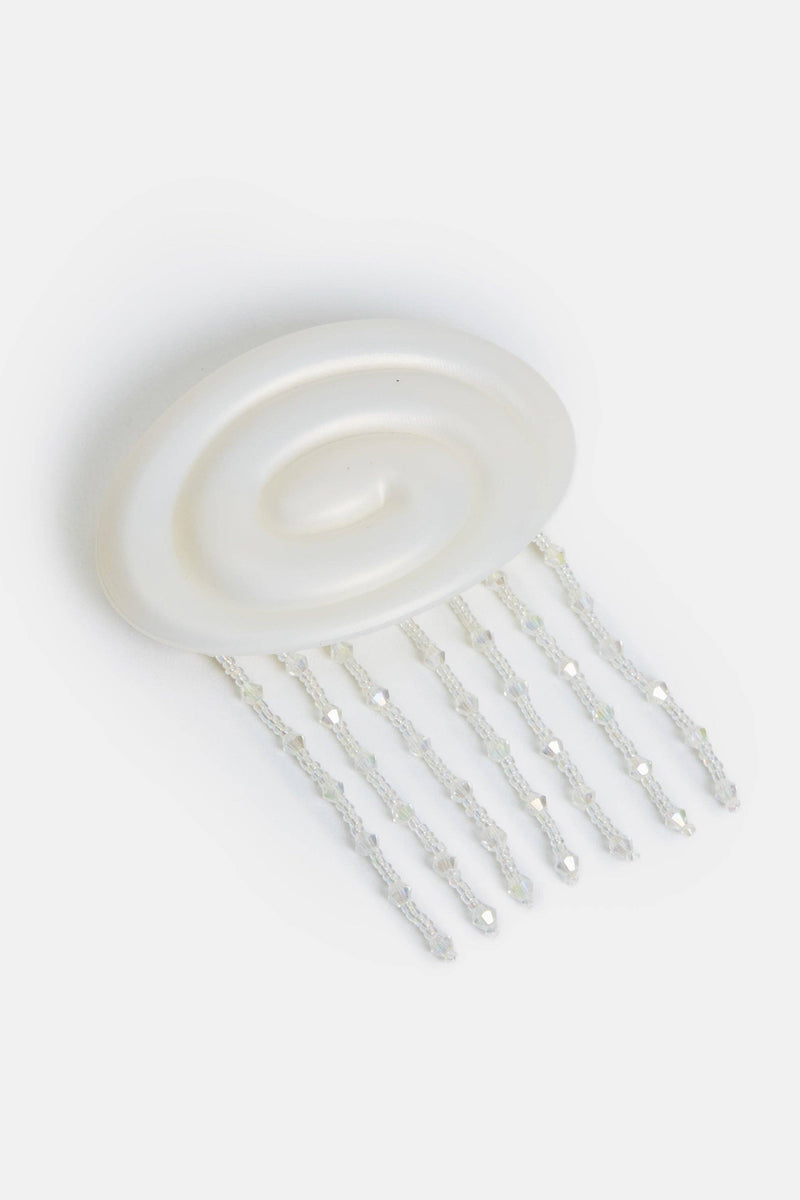 White hair comb on a light gray background
