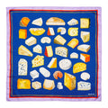 A silk scarf with a variety of hand painted cheeses arranged in a square with a blue background and a stripe border.