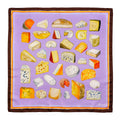 A silk scarf with a variety of hand painted cheeses arranged in a square with a lavender background and a stripe border.