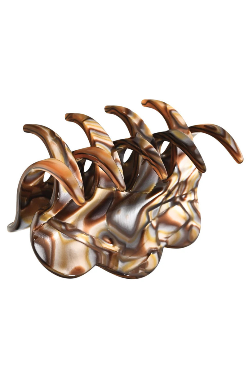 A metallic claw-style hair claw clip with a marbled pattern of bronze, gold, and brown tones, shown on a plain white background.