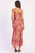 Woman wearing a patterned dress on a white background