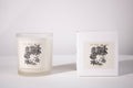 Frosted glass candle with floral design and matching box on a white background
