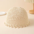 Beige crocheted lampshade with pearl embellishments on a light background