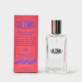 A clear glass perfume bottle with a silver cap stands next to its pink packaging box, both featuring the brand name 'BLOMB' in blue text, on a clean white background.