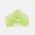 Green silicone elephant with a pearl charm on a white background