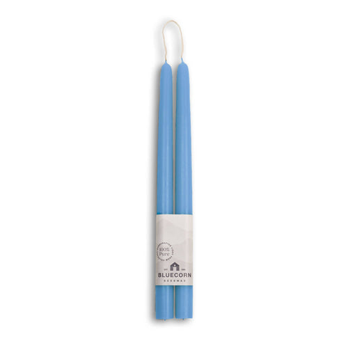 Two blue candles in a white holder with 'Bluecorn' branding on a white background