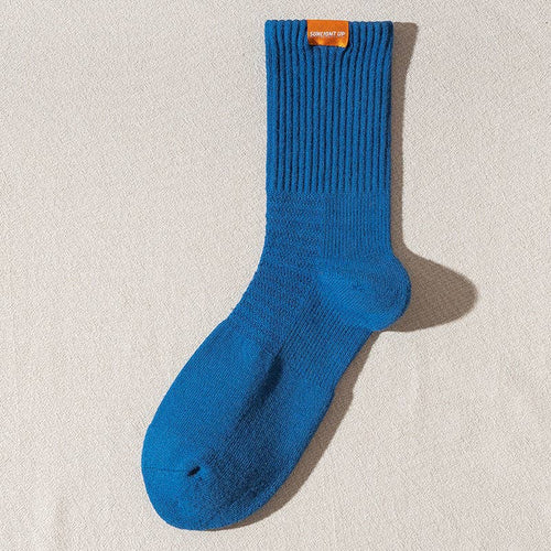 Blue sock with a brand label on a beige background