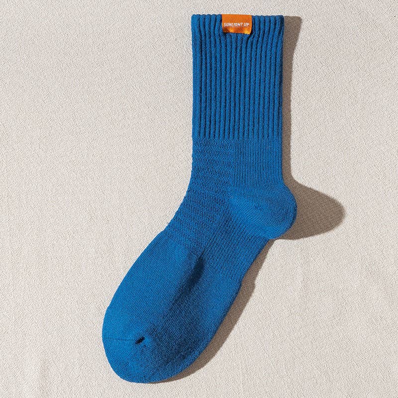 Blue sock with a brand label on a beige background