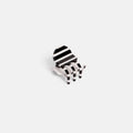 A small black and white striped claw clip shown on a plain light gray background.