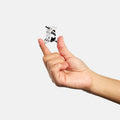 Small clip held between two fingers against a white background