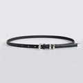 A slim black leather belt with silver-tone metal hardware, including a buckle, keeper, and tip, displayed on a light gray background.