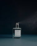 Clear spray bottle labeled 'Layerman' on a dark background