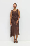 Woman wearing a brown lace dress against a white background